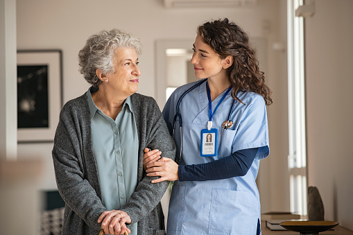 young caregiver helping a senior woman