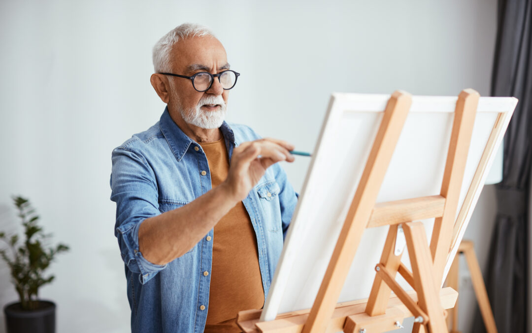 gentleman painting on a canvas