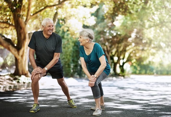senior couple exercising outdoors together